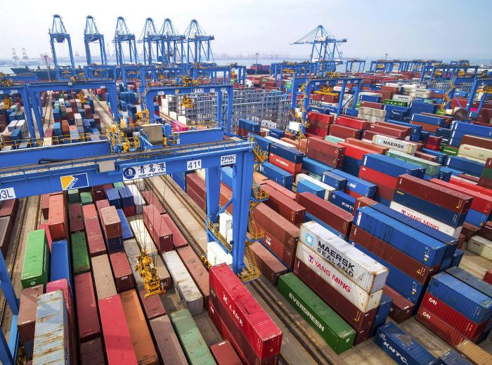 In this Tuesday, May 14, 2019, photo, containers are piled up at a port in Qingdao in east China's Shandong province. China's imports from the United States plunged 31.4% in June from a year earlier amid a tariff war with Washington, while exports to the U.S. market sank 7.8%, Customs data showed Friday, July 12, 2019. (Chinatopix via AP)